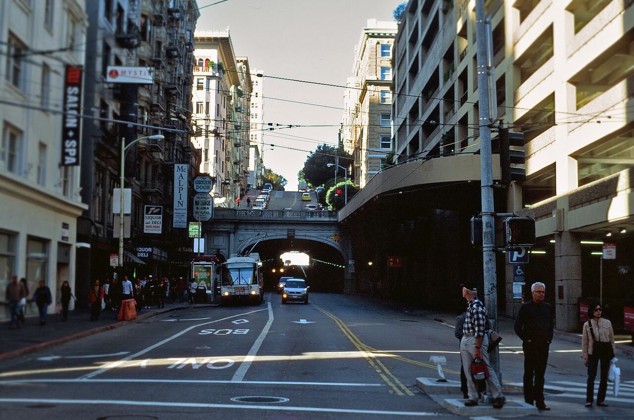 City street leading into a tunnel with passing traffic