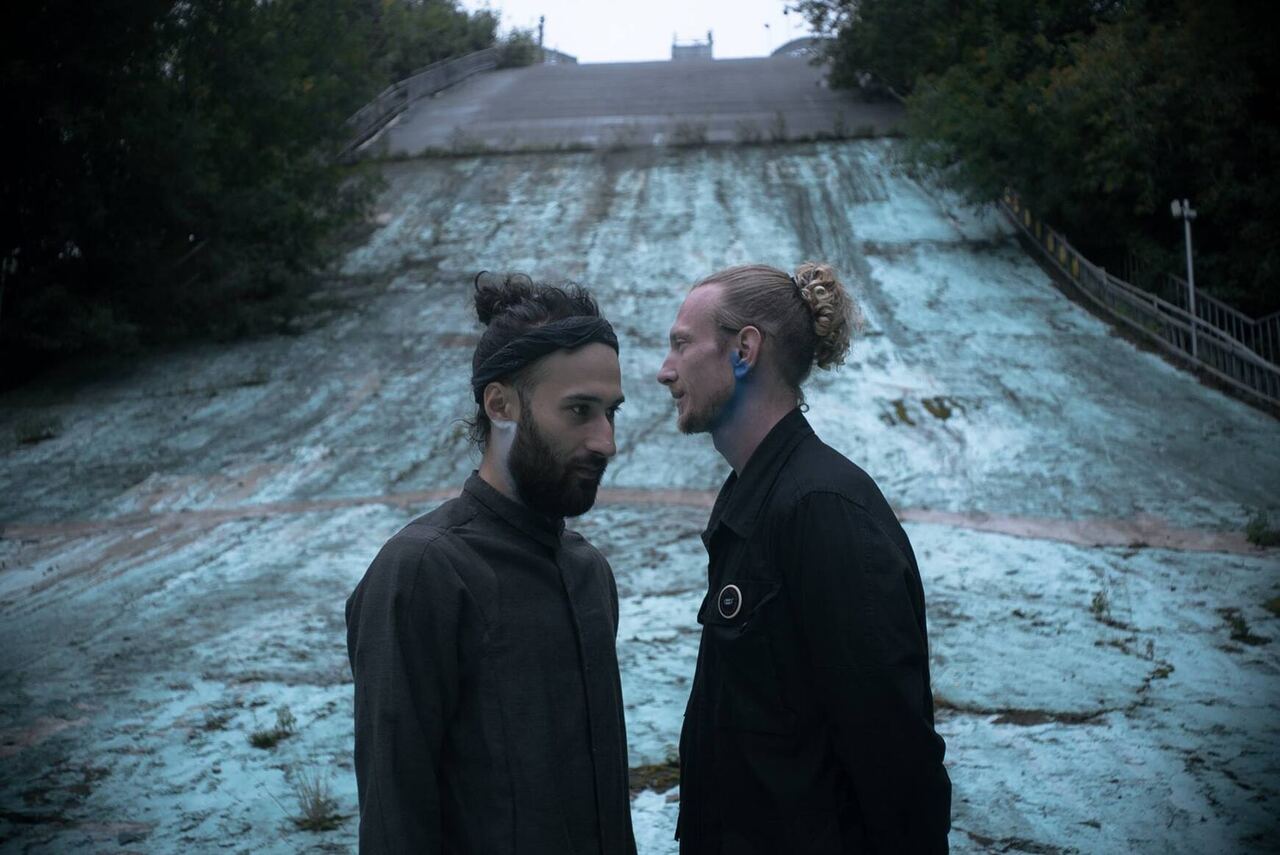 Two men face to face on a concrete slope